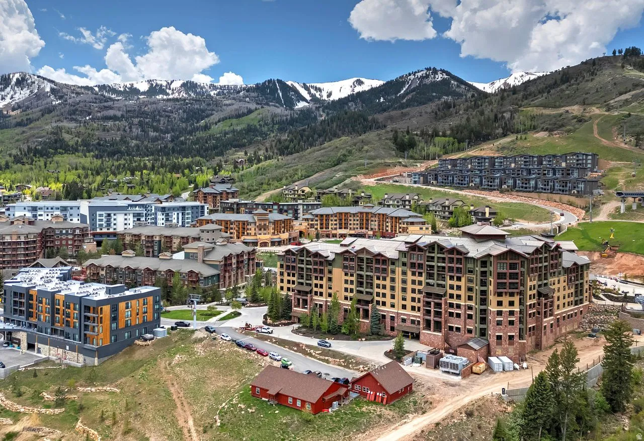 Mountain landscape featuring multiple multi-story condominium buildings with varied architectural styles