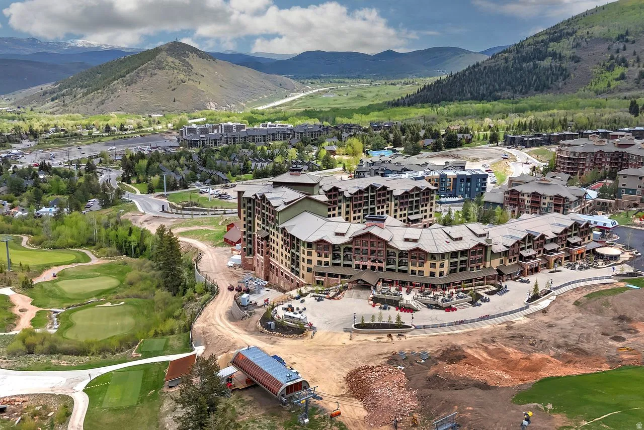 Expansive multi-story complex featuring a stone and wood exterior with multiple balconies
