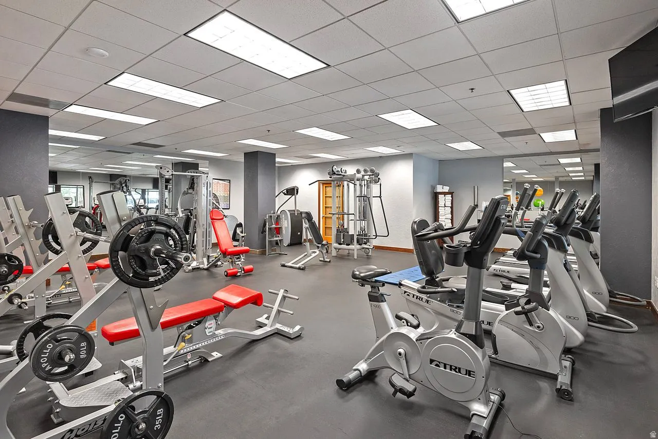 Equipped fitness center featuring diverse exercise machinery, weight training stations, and a rubberized floor