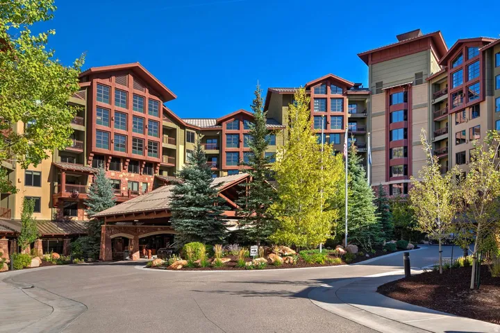 Multi-story building featuring natural wood elements and stone accents