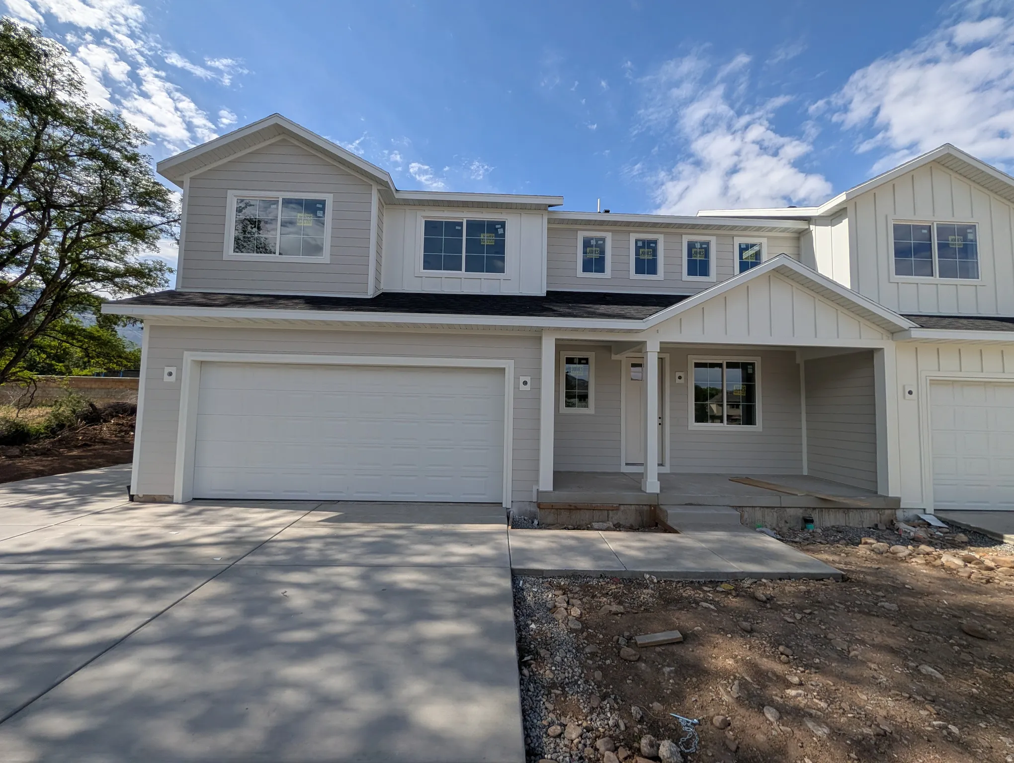 Contemporary exterior with light gray siding and white trim