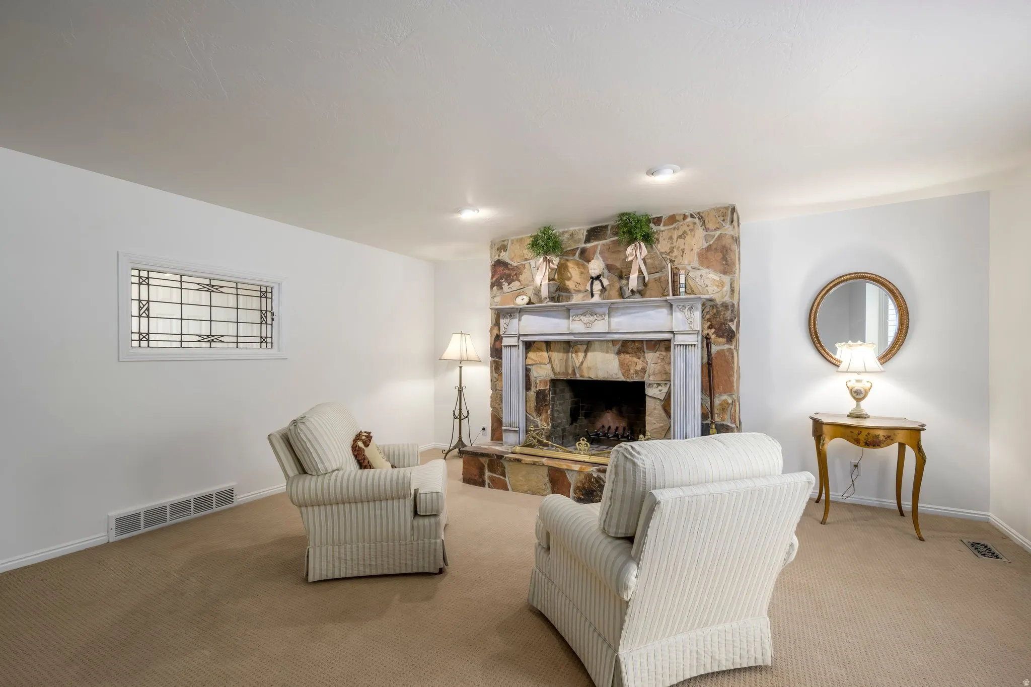 Stone-clad fireplace with a decorative mantel and hearth