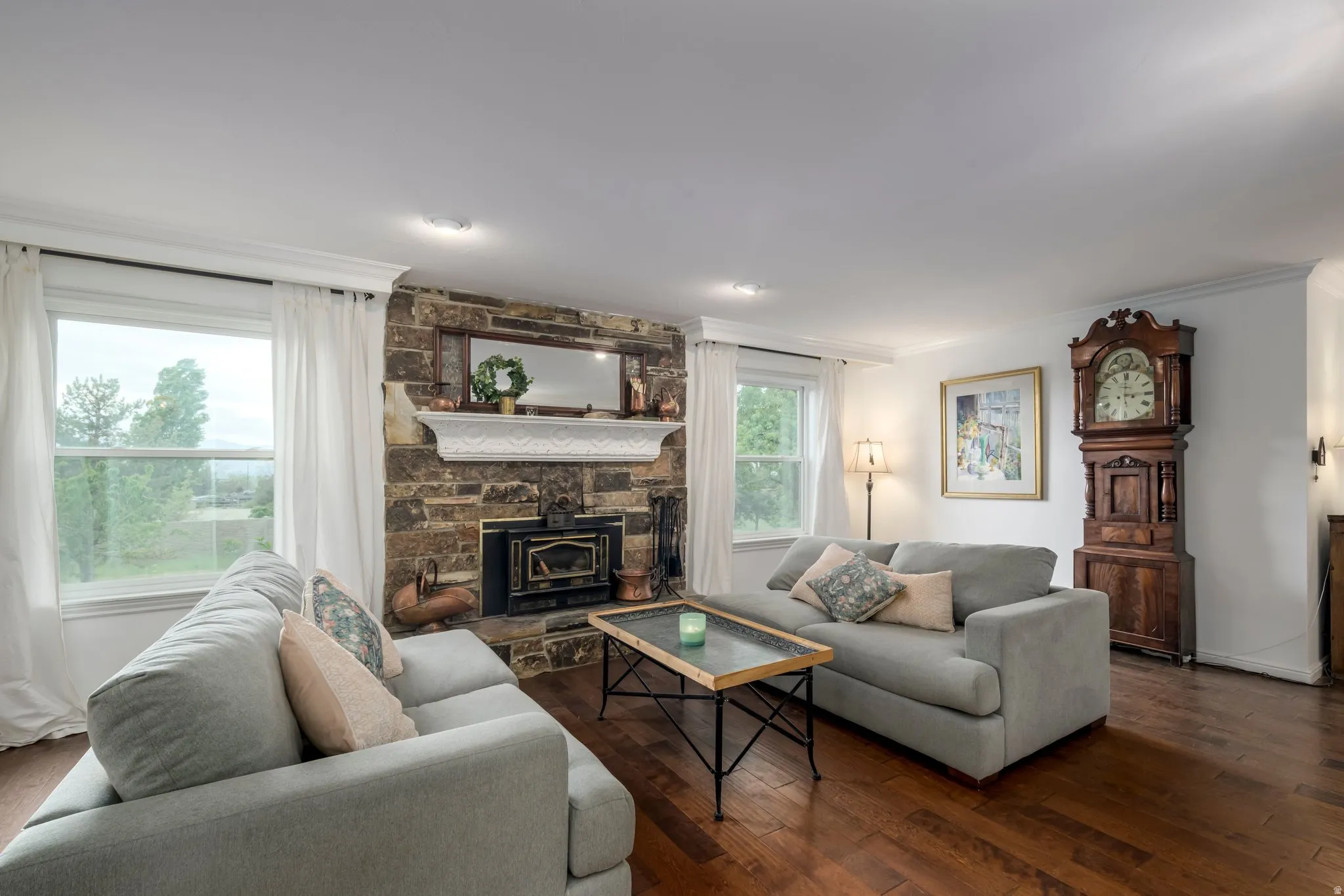Family Room featuring a stone accent wall with a fireplace insert, white mantel, and wood-finish flooring