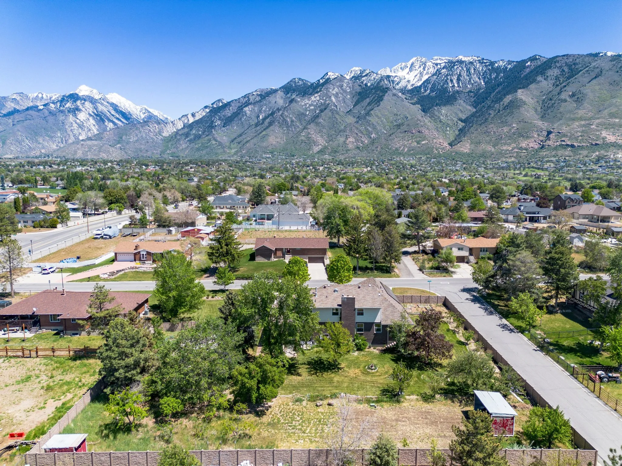 Expansive residential area featuring snow-capped mountains and verdant trees