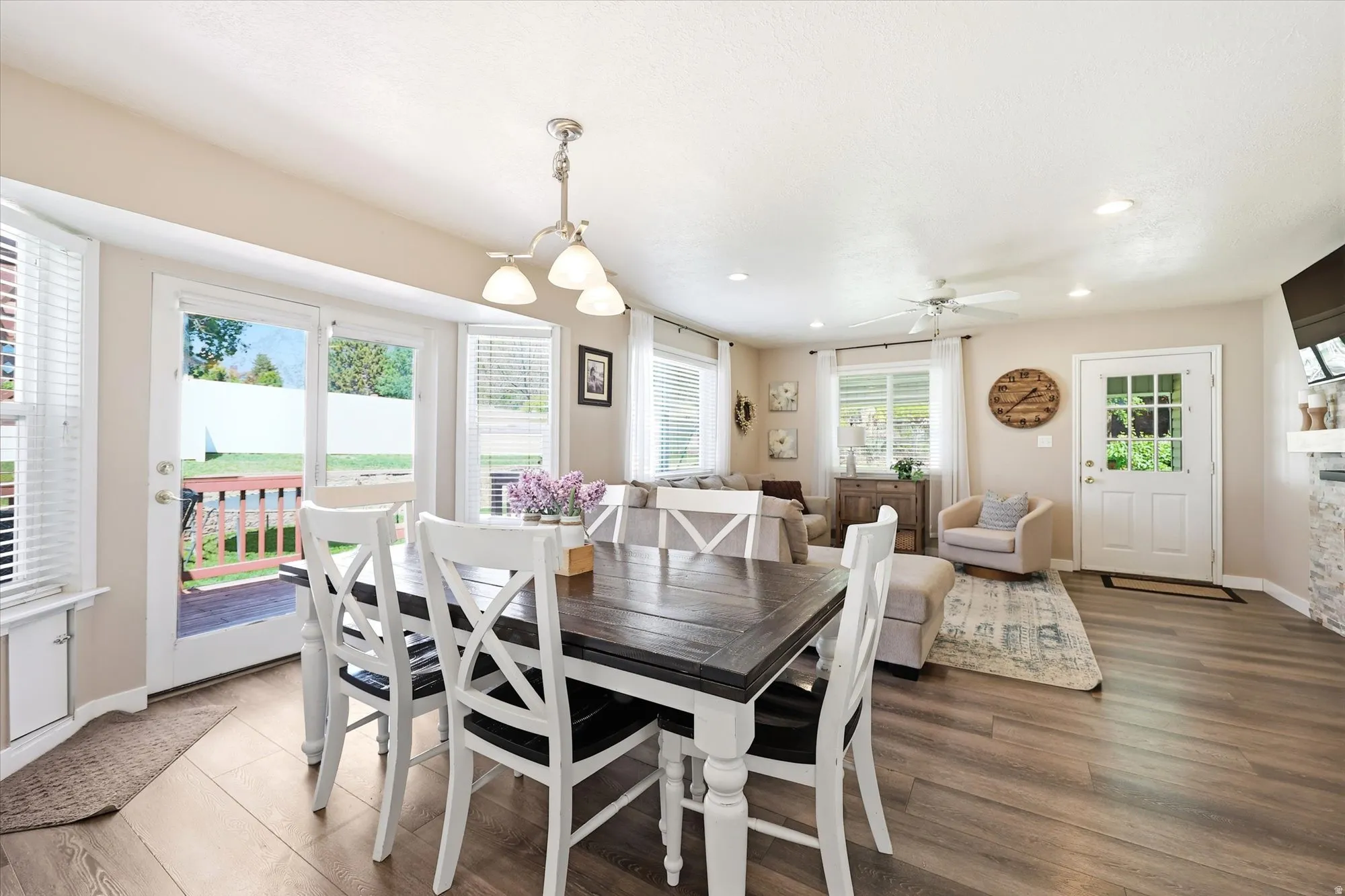 Open-concept living area featuring wood-finish flooring, recessed lighting, and a ceiling fan