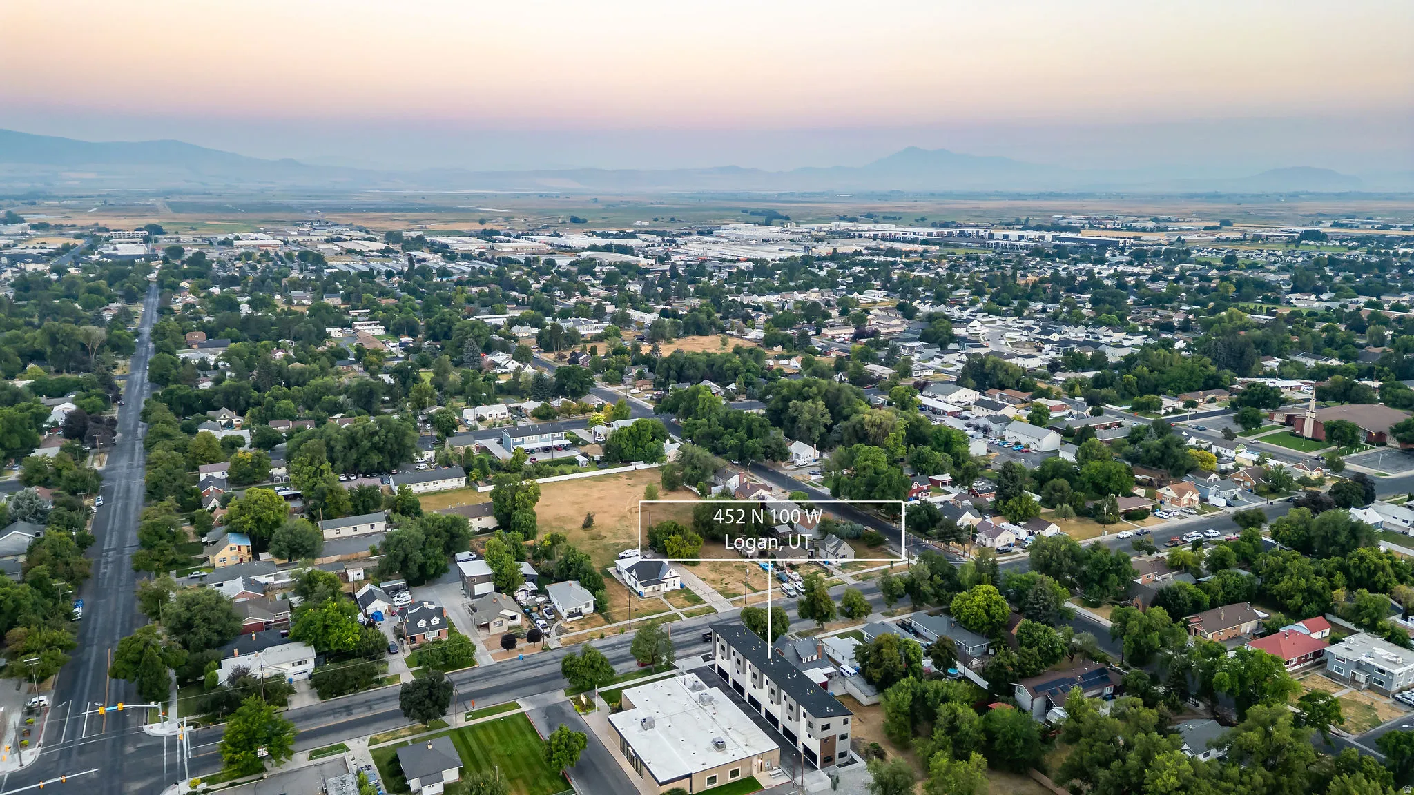 Aerial perspective showcasing a developed urban area with mountains in the background