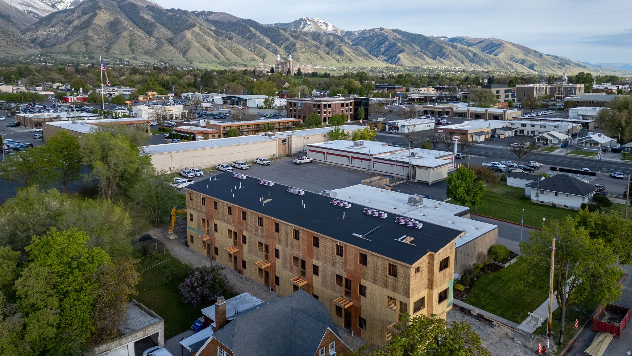 Under-construction multi-unit residential building featuring a flat roof and multiple levels