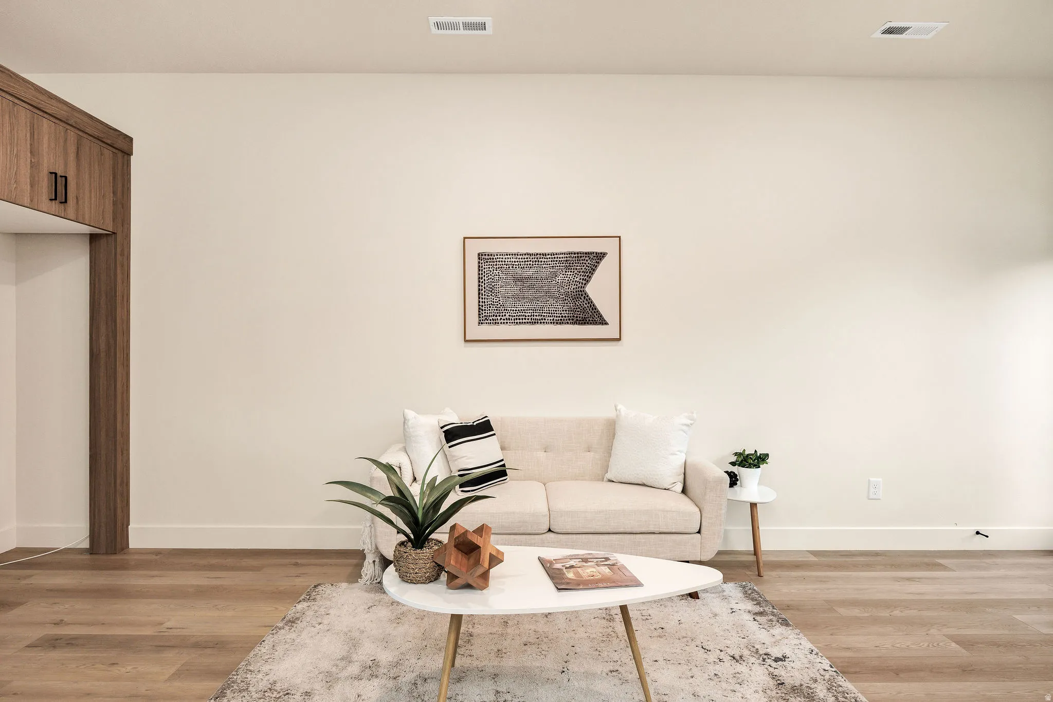 Expansive interior space featuring light wood-finish flooring, recessed lighting, and a neutral color palette