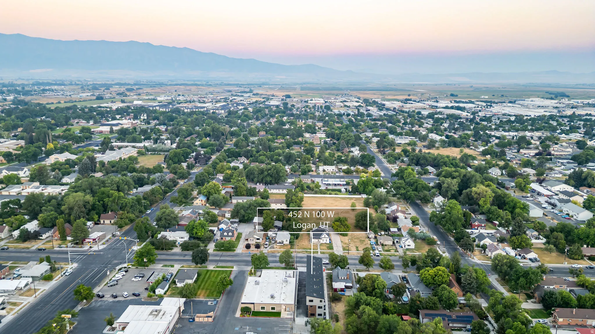 Aerial perspective showcasing a residential area with a prominent mountain range in the background