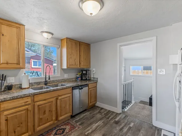Kitchen featuring wood cabinetry, granite-finish countertops, and stainless steel appliances