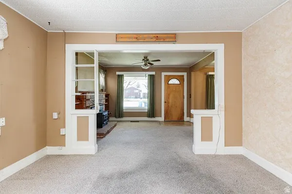 Carpeted floor with light beige walls and white trim