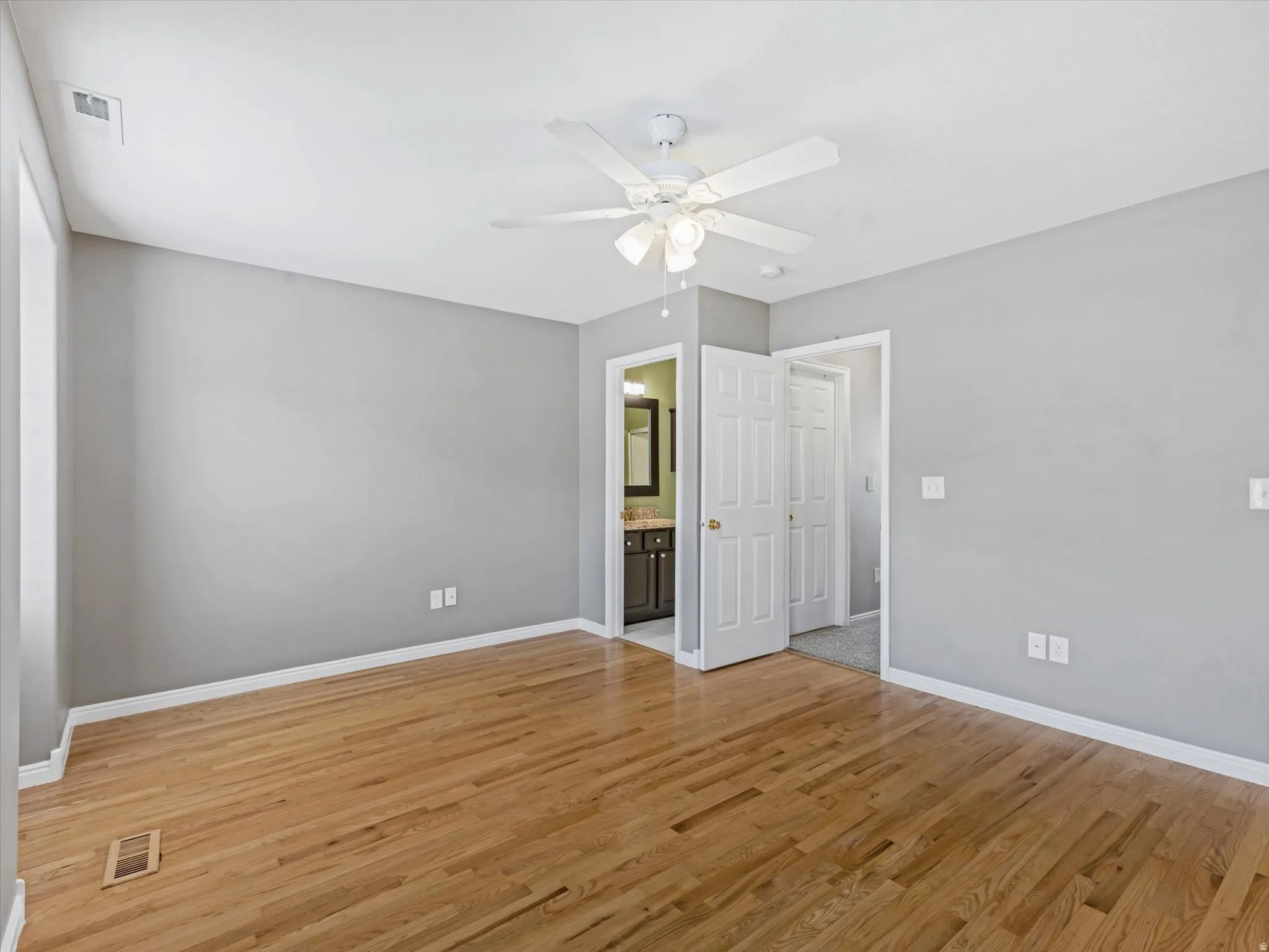 Hardwood flooring in a bright room with light gray walls