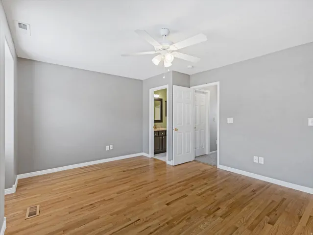 Hardwood flooring in a bright room with light gray walls