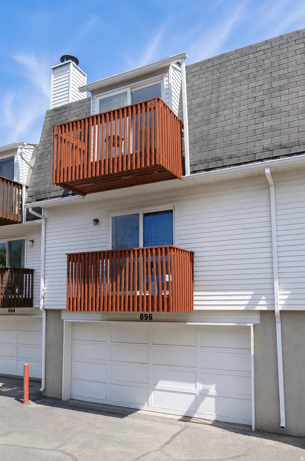 White siding exterior with attached garages