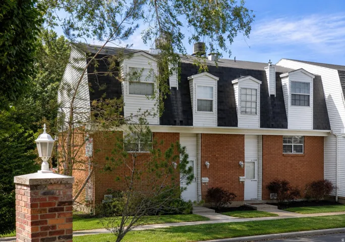 Brick and siding exterior with a mansard roof