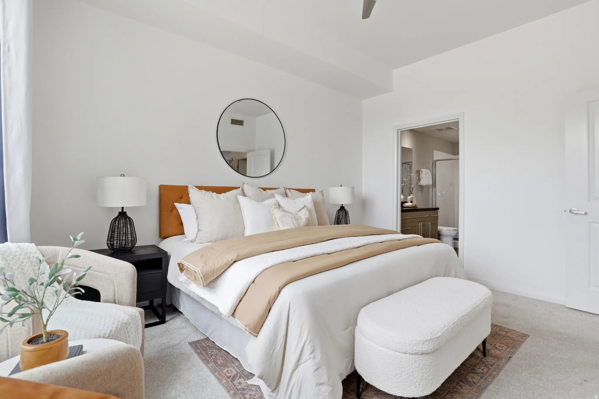 Carpeted bedroom featuring white walls and a ceiling fan