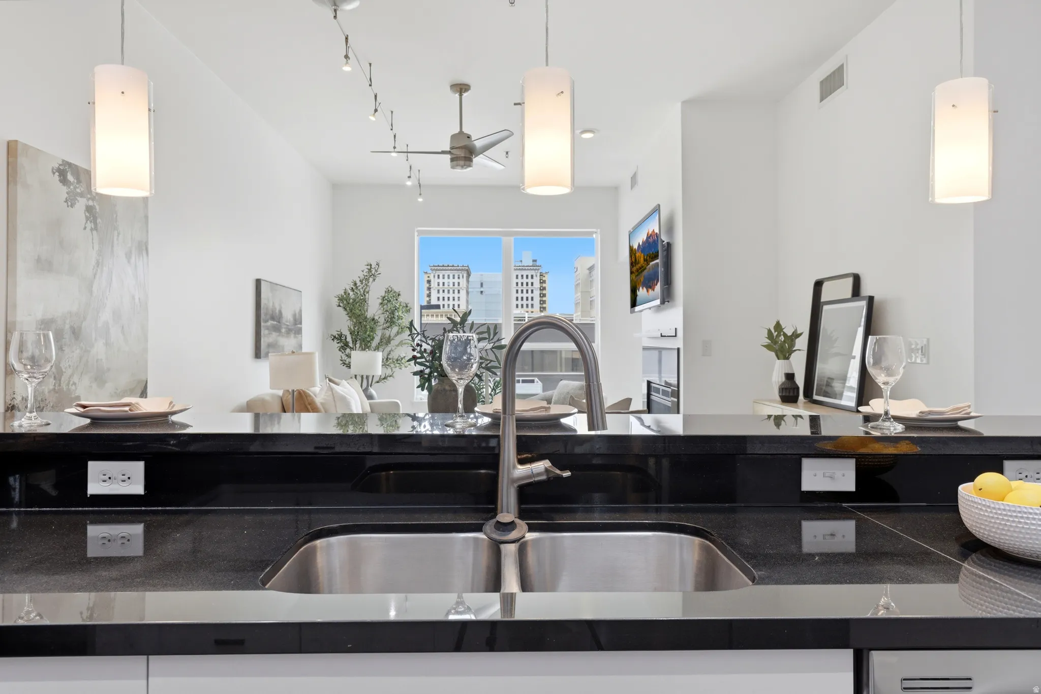 Kitchen with black stone countertops and stainless steel sink