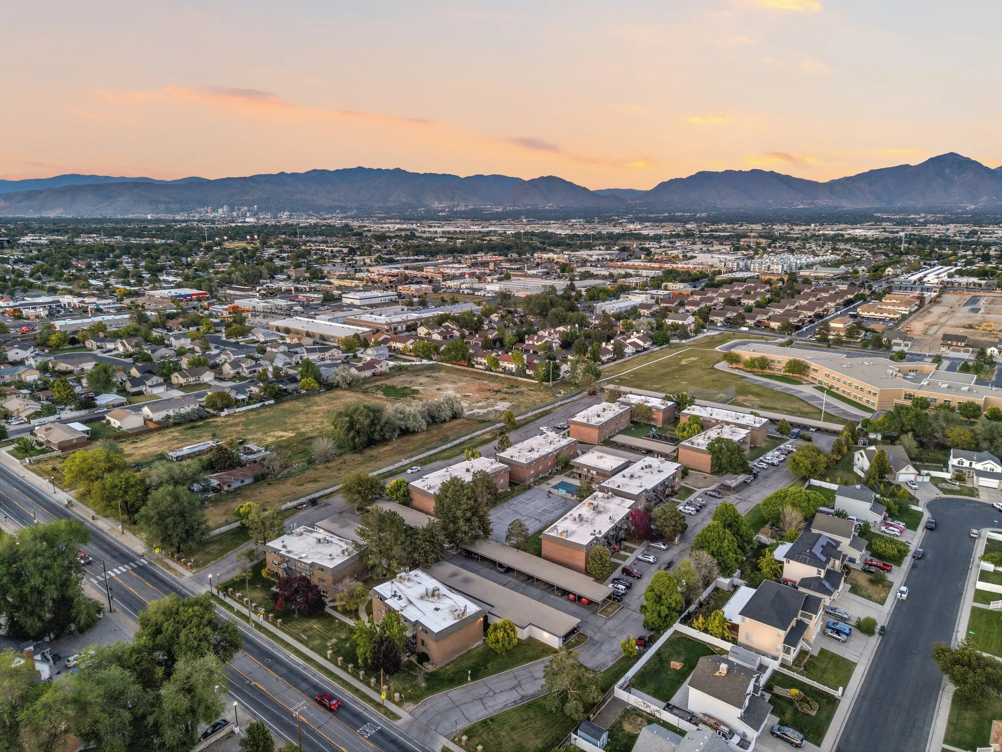 Expansive aerial perspective showcasing a residential area with a mountain backdrop