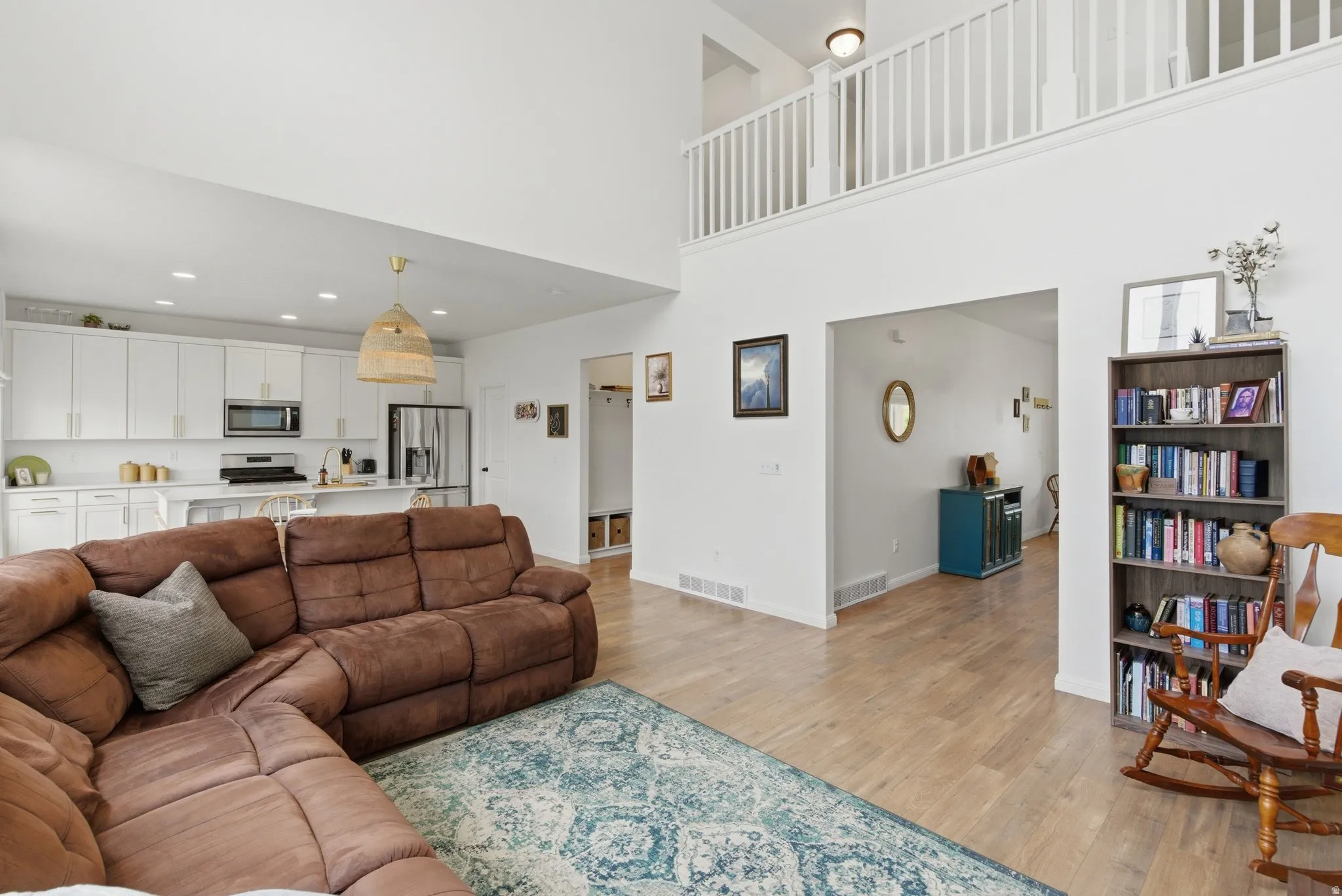 Vaulted living area featuring wood-finish flooring and an open concept layout