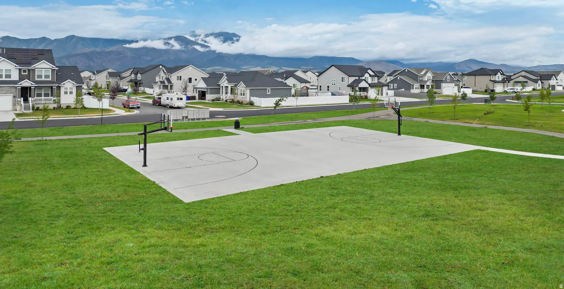 Community basketball court with a concrete surface and two hoops