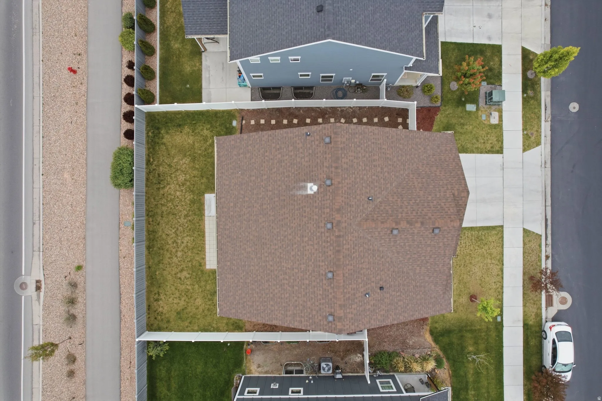 Brown shingle roof with multiple vents and a chimney