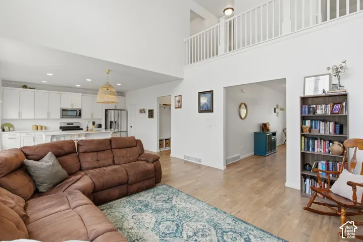 Vaulted living area featuring wood-finish flooring and an open concept layout