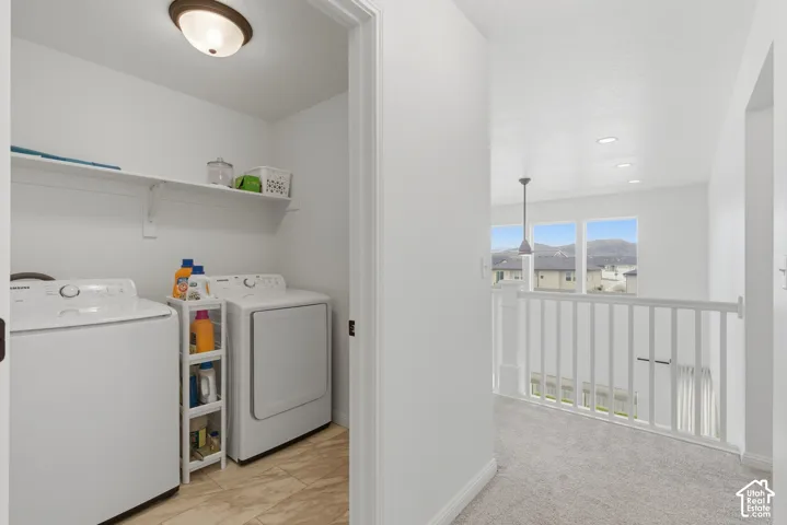 Dedicated laundry space featuring a white shelf and tiled flooring