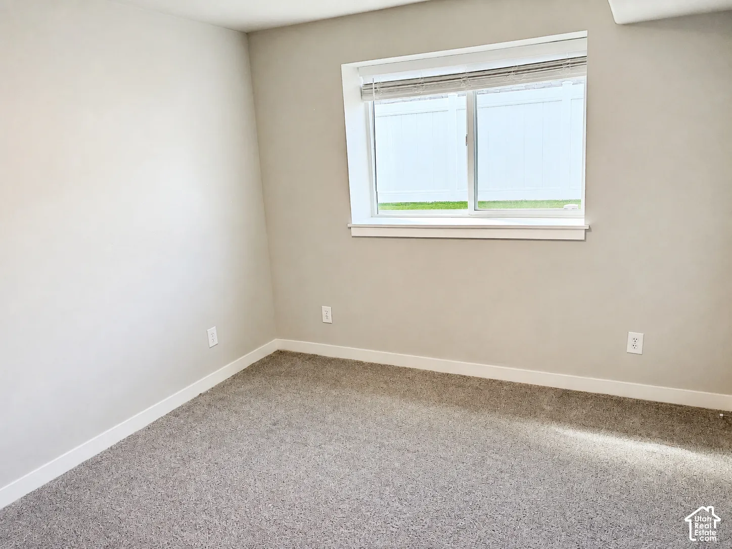 Neutral-toned walls complement plush carpeting