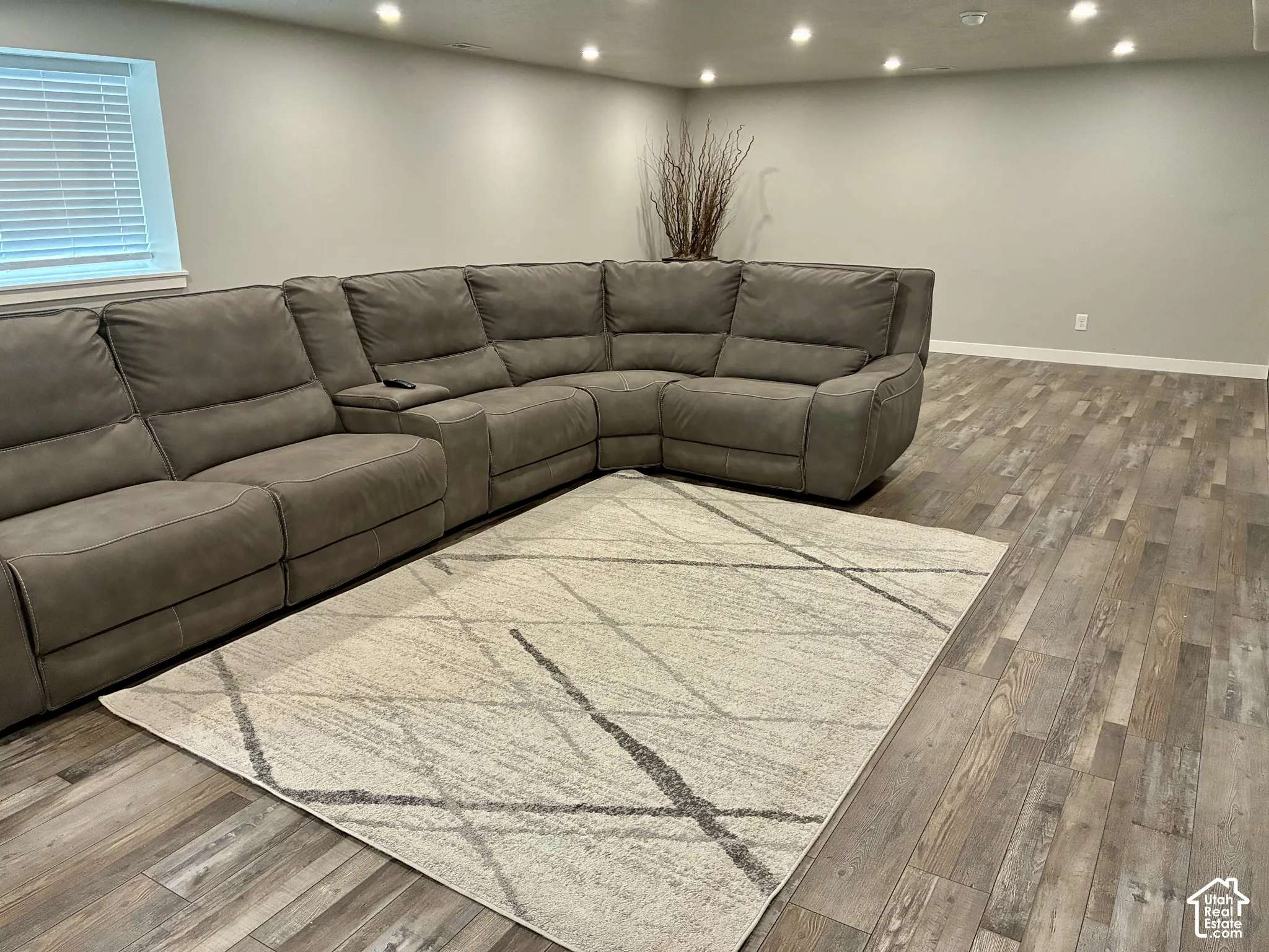 Recessed ceiling lighting, wood-finish flooring, and light-toned walls