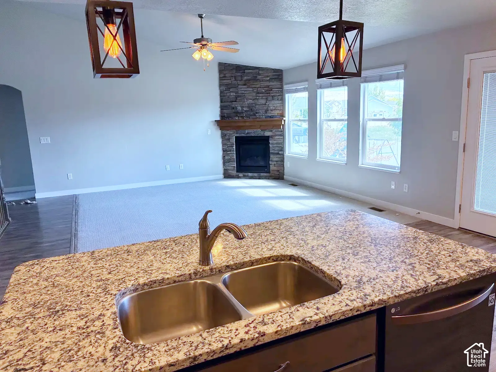 Kitchen island with a double basin stainless steel sink and granite-style countertop