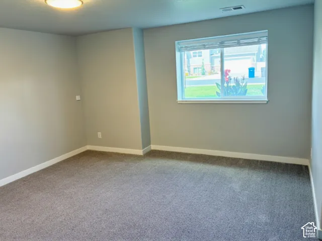 Recessed lighting, wall-to-wall carpeting, and a window with blinds