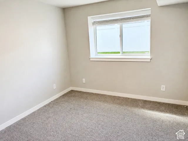 Neutral-toned walls complement plush carpeting