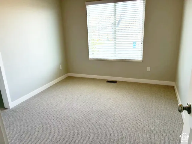 Neutral-toned walls complement the textured carpeting