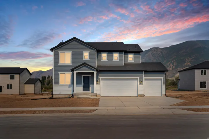 **DISCLAIMER** Elevation may vary. Contemporary two-story residence featuring a dark gray roof, light gray siding, a covered front entry, and a multi-car garage