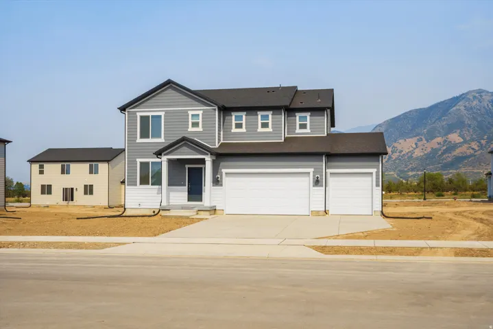 **DISCLAIMER** Elevation may vary. Two-story residence featuring gray siding with white trim accents