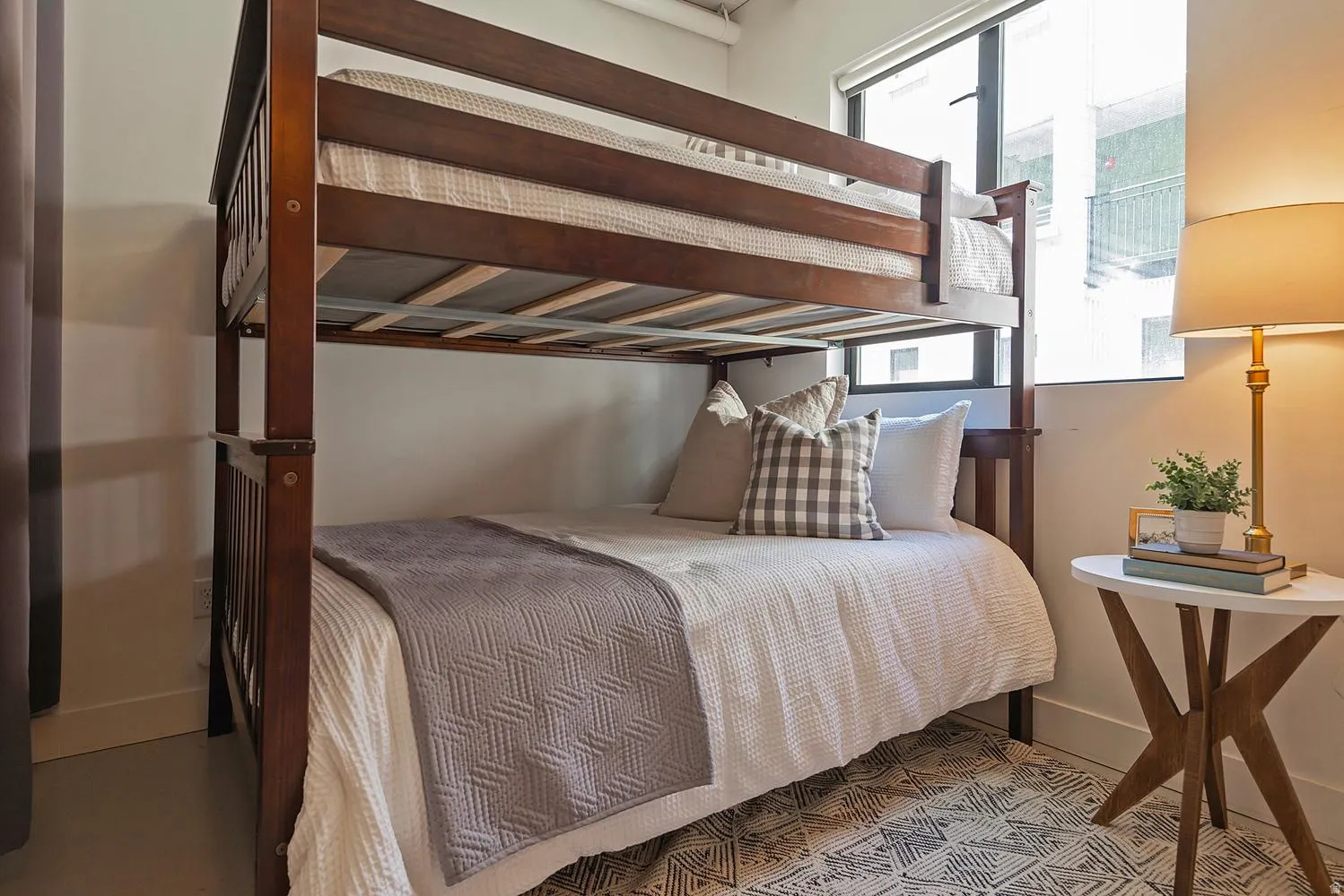 Dark wood-finish bunk bed frame with a lower mattress