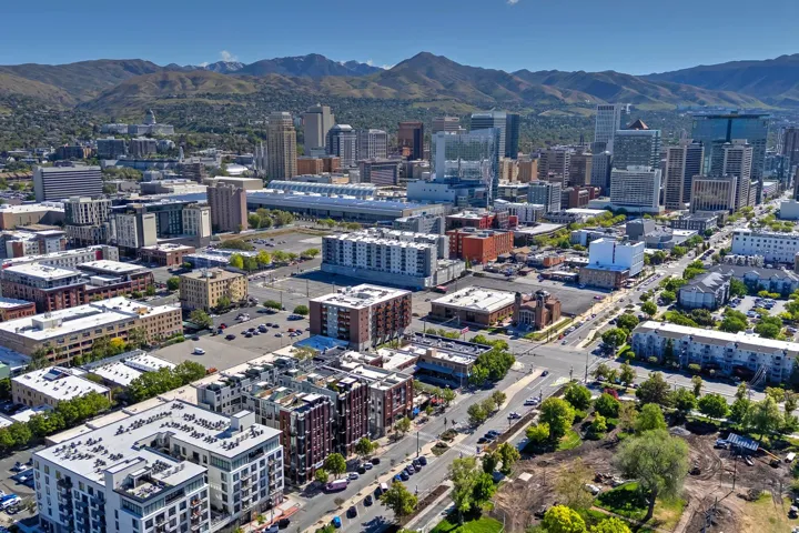 Aerial perspective showcasing a vibrant urban landscape with a backdrop of distant mountains