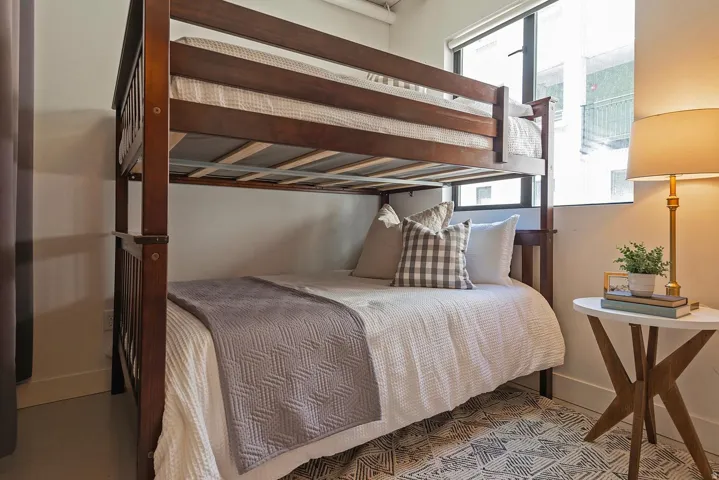 Dark wood-finish bunk bed frame with a lower mattress