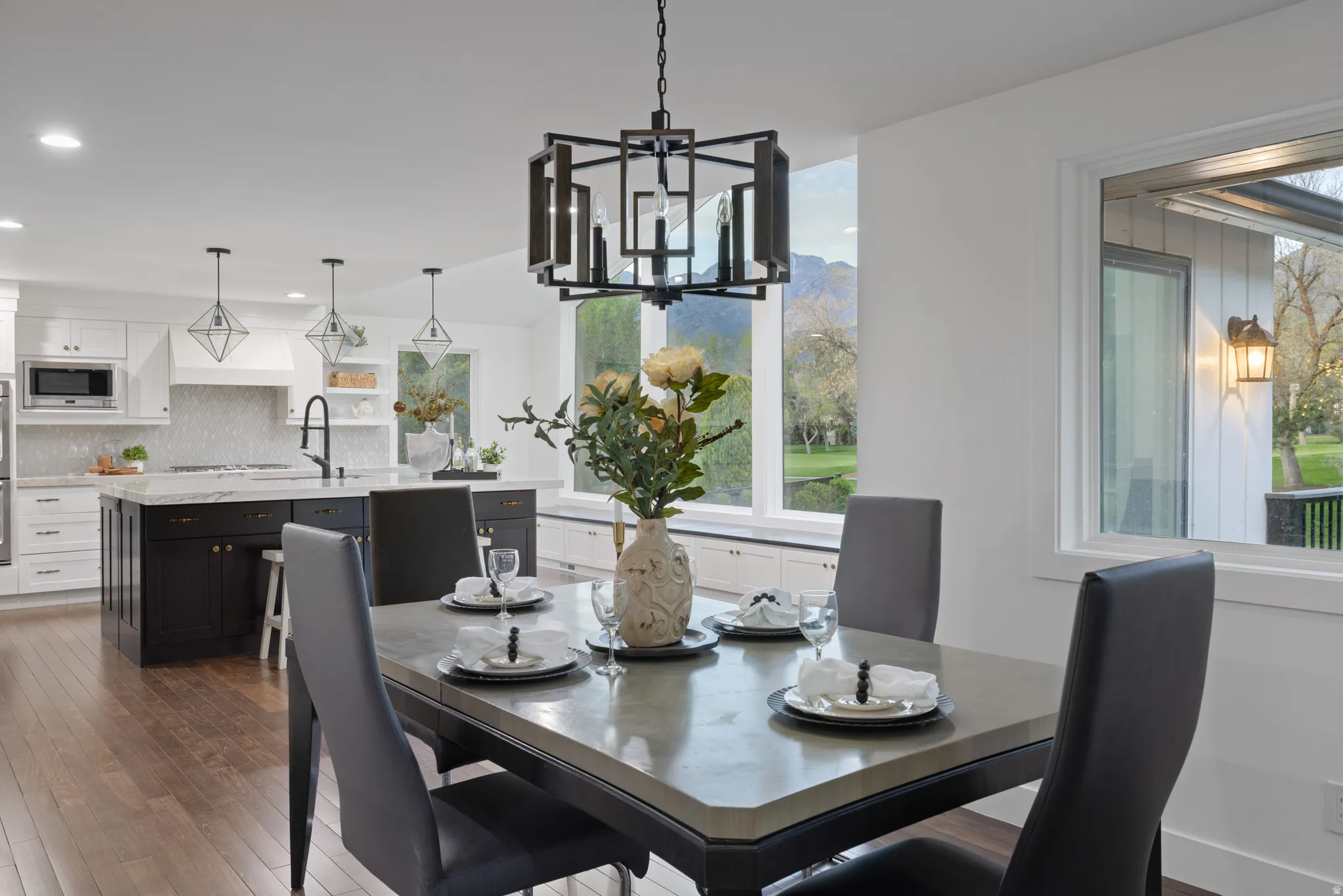 Dining area with a contemporary chandelier and large windows