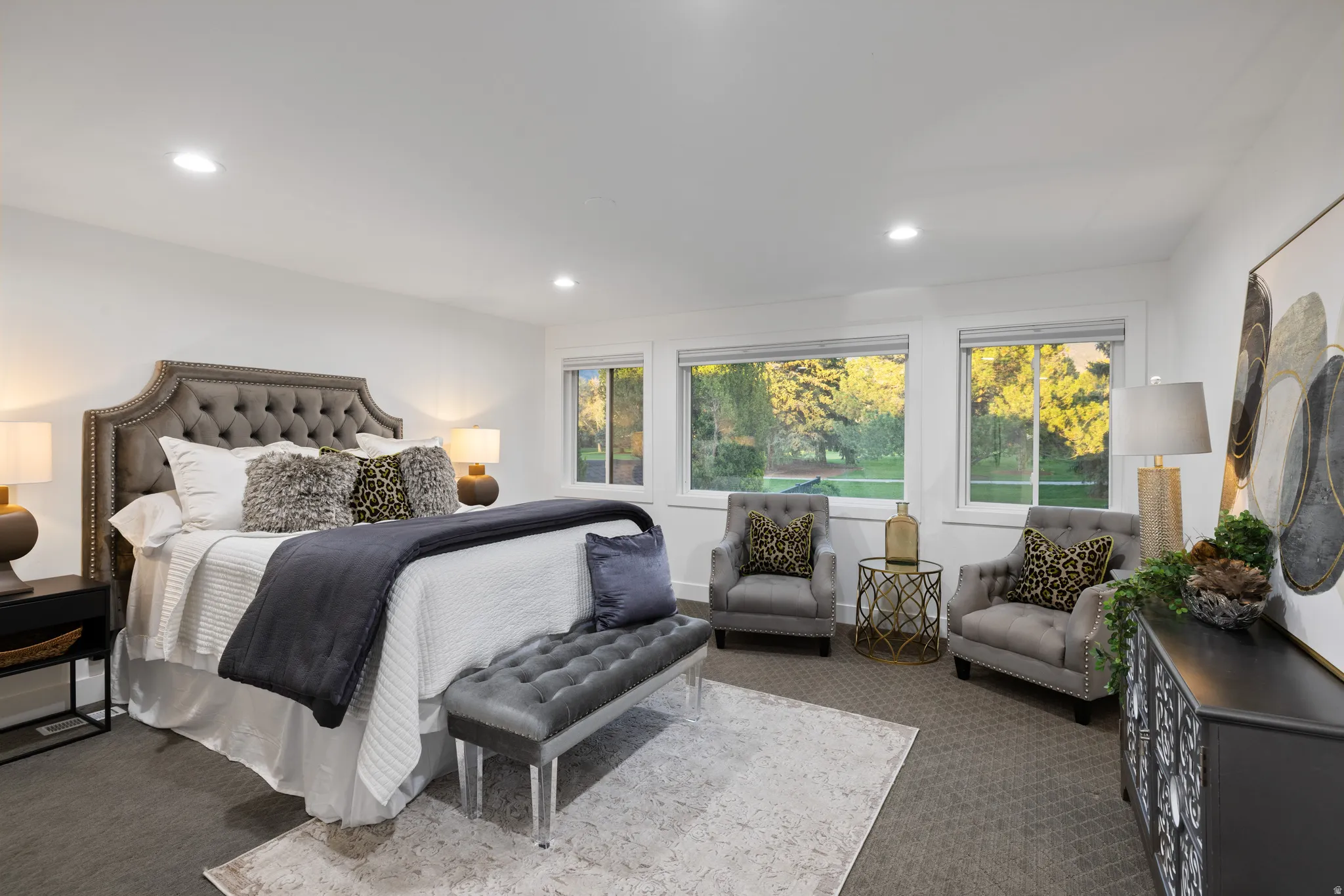 Spacious room featuring broad windows with exterior views, recessed lighting, and neutral-toned carpeting