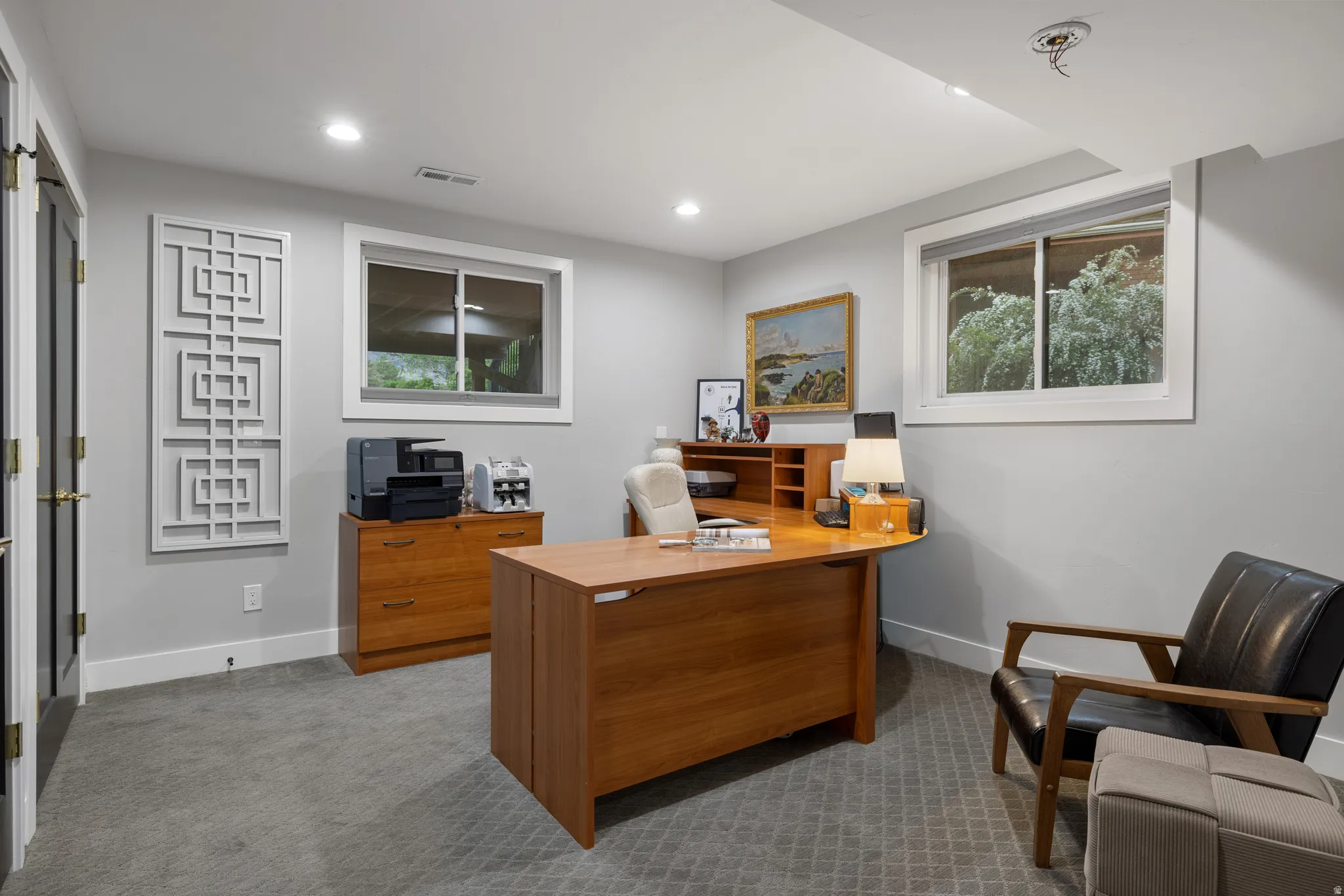 Dedicated interior space featuring two windows, recessed lighting, and a textured carpeted floor