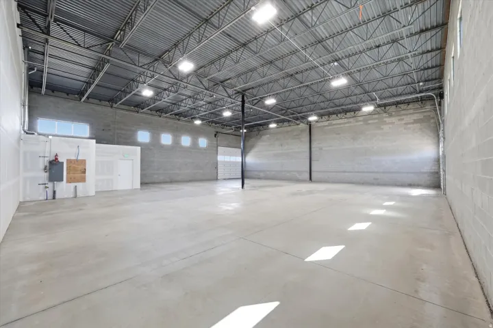 Spacious commercial interior featuring a concrete floor and block walls