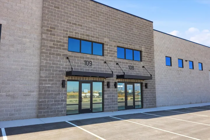 Modern commercial building featuring gray brick construction with black trim accents