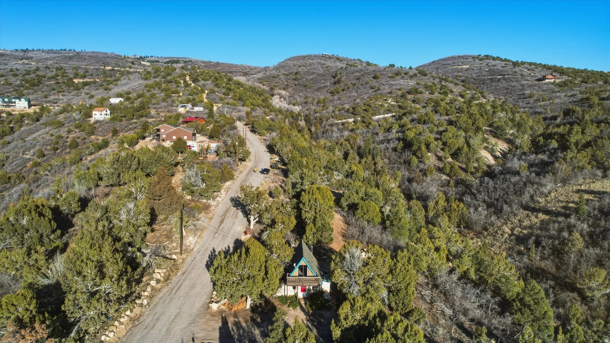 Drone / aerial view of mountains and a heavily wooded area