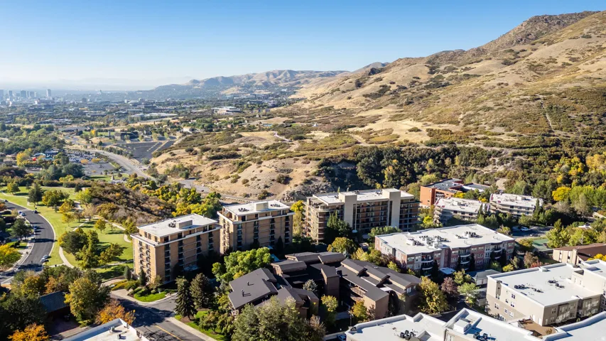 Aerial perspective showcasing multiple residential buildings nestled into a hillside landscape