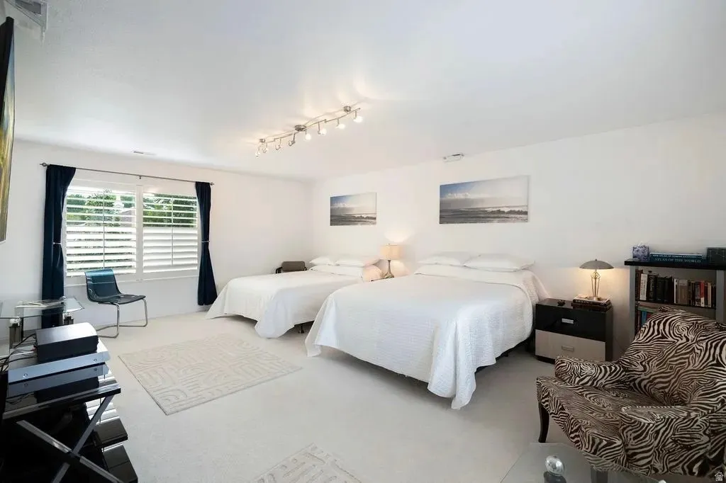 Spacious room featuring white walls and light-colored flooring