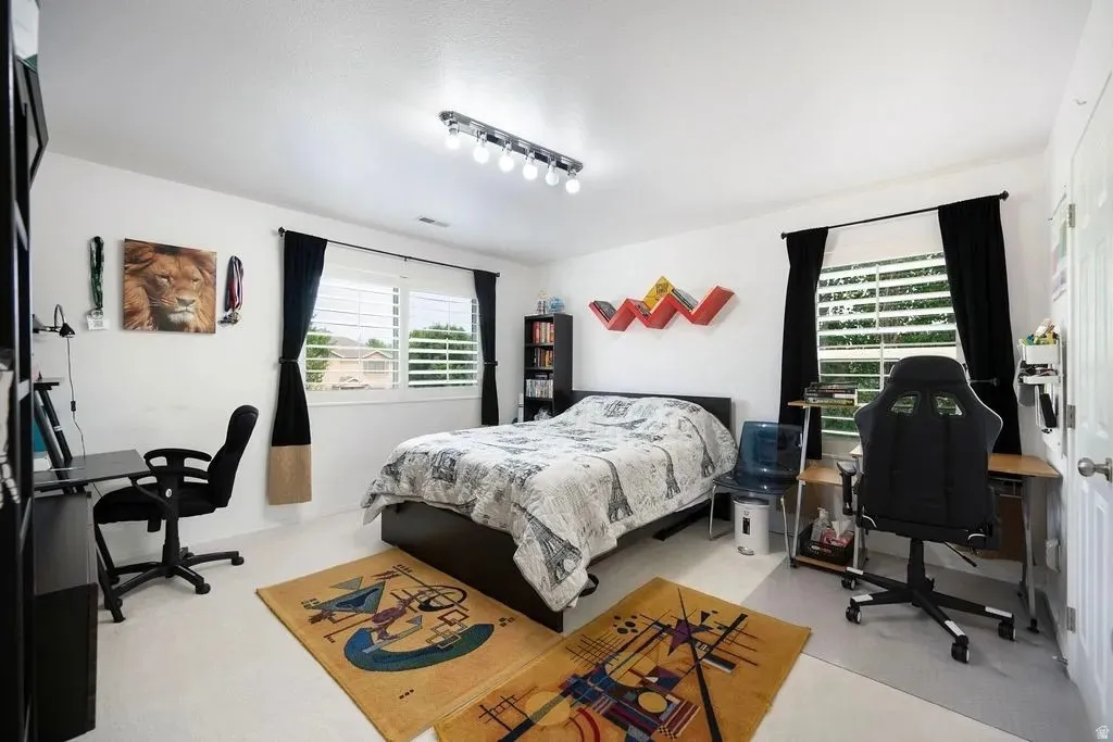 Bright room featuring white walls and light-colored flooring