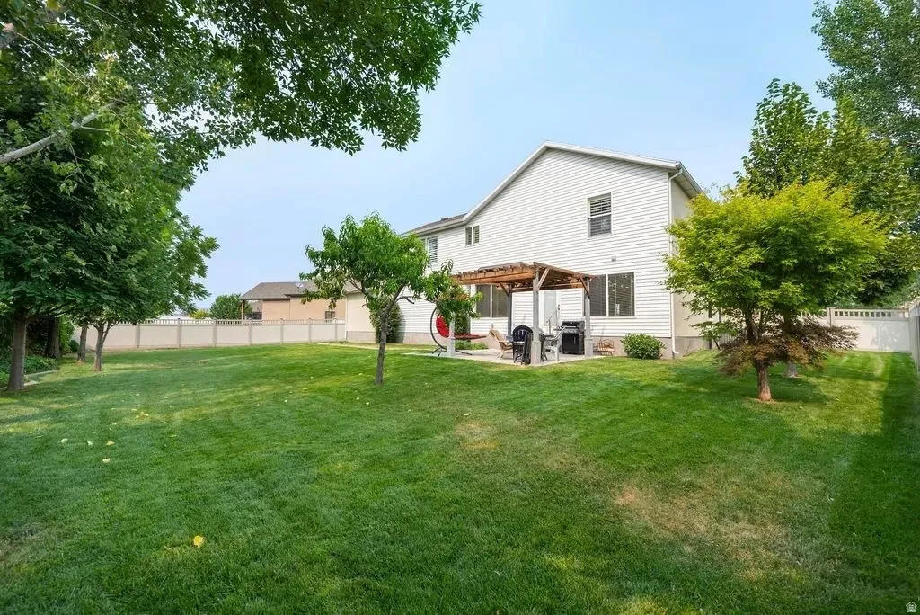 Expansive green lawn with mature perimeter trees