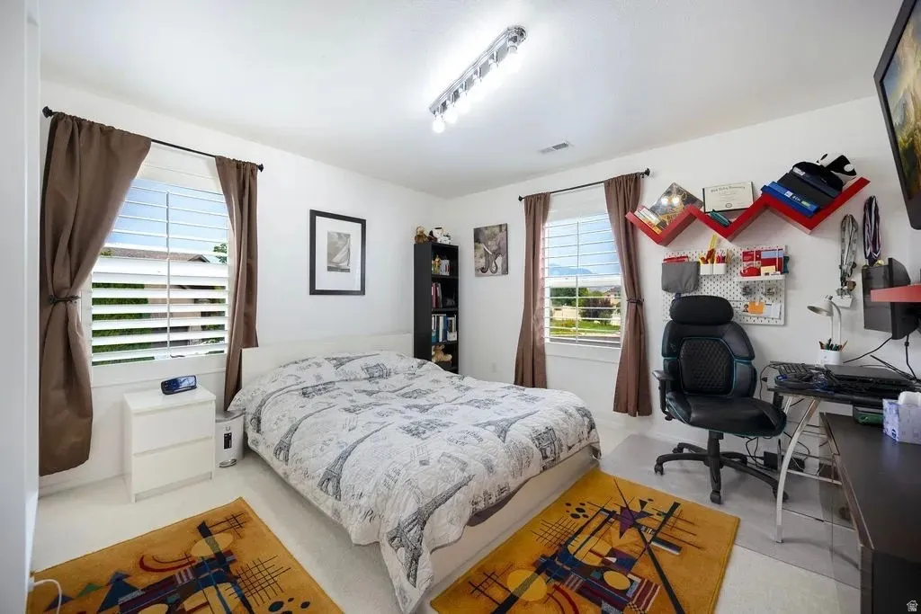 Bright room featuring white walls and a white ceiling with recessed lighting