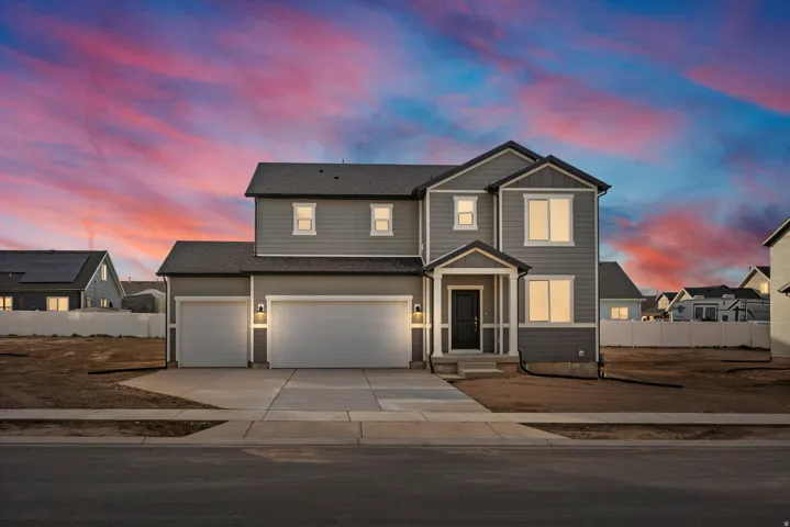 **DISCLAIMER** Exterior elevation and color may vary.  Two-story home with a multi-gabled roofline, featuring gray siding and white trim accents